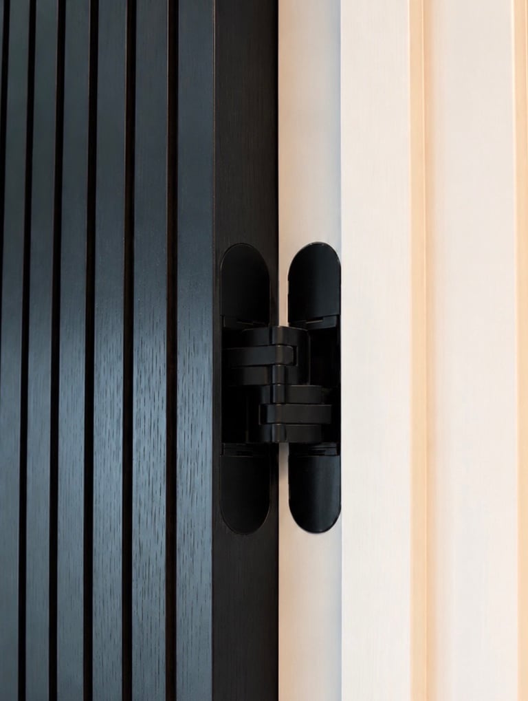 Black concealed hinge on modern striped wooden door with vertical paneling and minimalist design