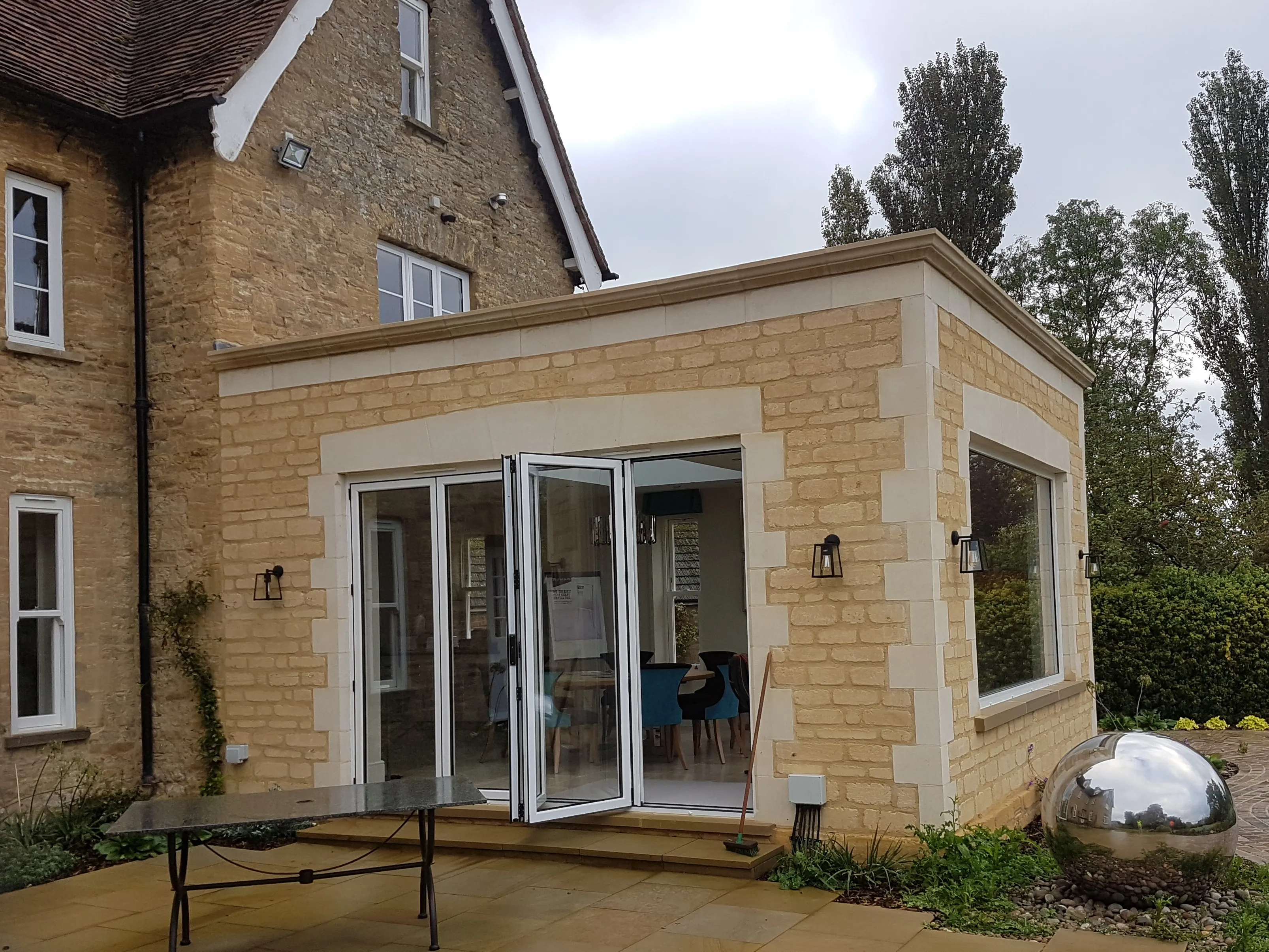 A house with a patio and a table outside.