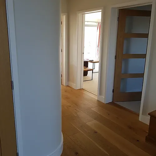 a room with a door, a table and a chair