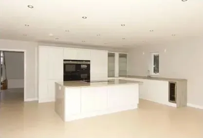 there is a kitchen with a large island in the middle of it